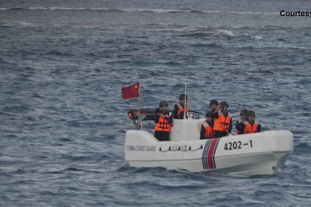 In this image released by the Philippine Coast Guard, a Chinese boat sails around Sandy Cay. Photo: AP