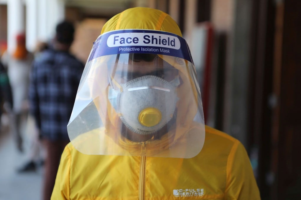 A Kashmiri boy wearing a mask and face shield in Srinagar, the summer capital of Indian Kashmir, in May of 2020. Photo: EPA-EFE