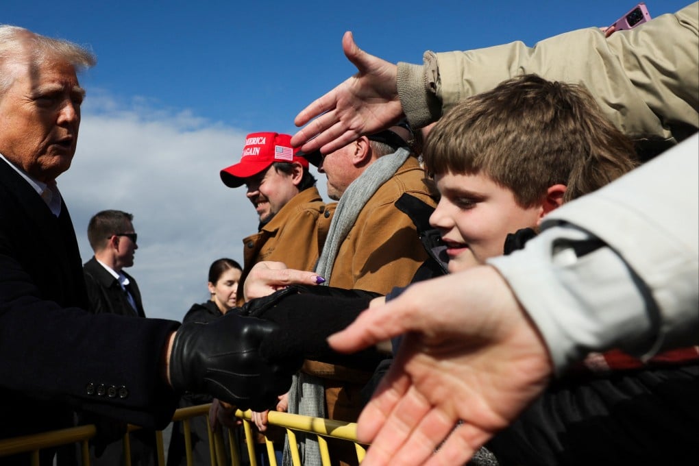 US President Donald Trump greets supporters, as he arrives to assess recovery efforts and tour areas devastated by Hurricane Helene in Asheville, North Carolina, on Friday. Photo: Reuters