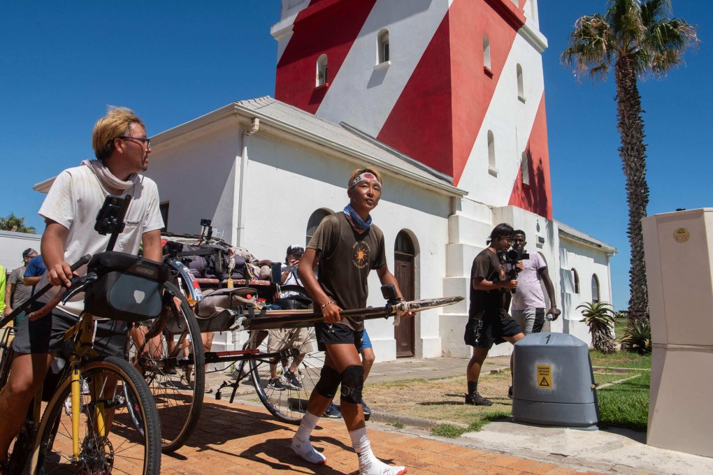 Yuji “Gump” Suzuki, a Japanese runner and social media sensation, pulls his rickshaw past Mouilie Point Light House in Cape Town, South Africa, at the end of a journey of 6,400km from Kenya. It is the 34-year-old tour guide’s latest rickshaw-pulling feat. Photo: AFP