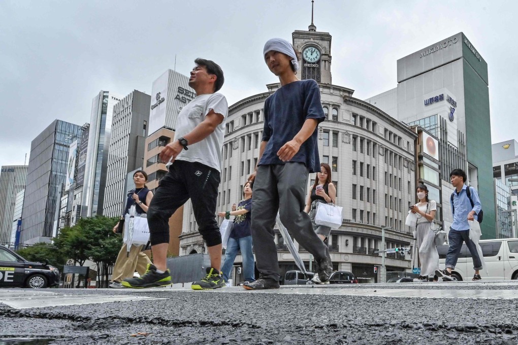 Pedestrians cross the street in the popular shopping district of Ginza, in central Tokyo, on August 16, 2024. Photo: AFP