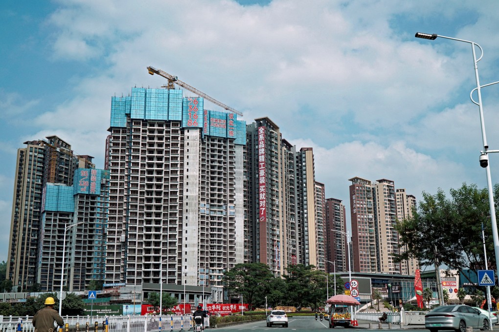Sale signs hang from residential buildings under construction in Huizhou, Guangdong province. The region has been hit particularly hard by China’s persisting real estate slump. Photo: Reuters
