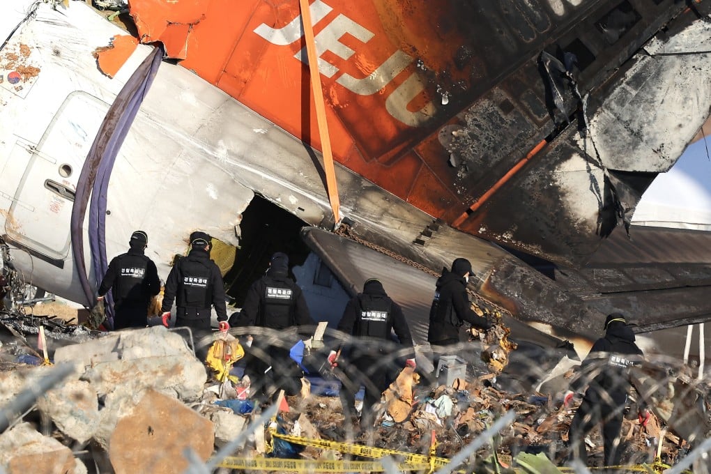 A forensics team inspects the wreckage of the Jeju Air plane that crashed at Muan International Airport. Photo: Yonhap/EPA-EFE