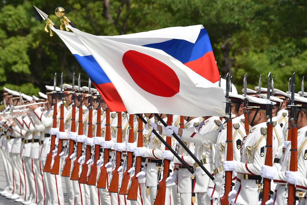 Honour guards hold the national flags of Japan and Russia before a welcome ceremony for Russia’s defence minister in Tokyo in 2019. Photo: AFP
