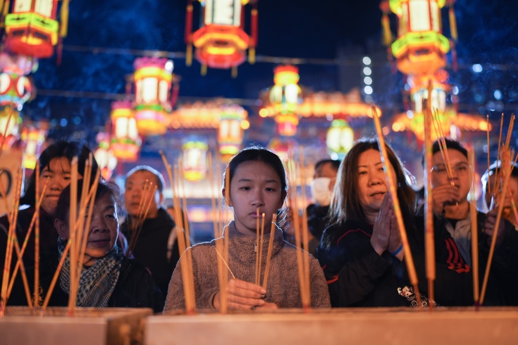 Folk wisdom suggests that the first to offer incense sticks at the main altar of the temple will receive the most blessings. Photo: Eugene Lee