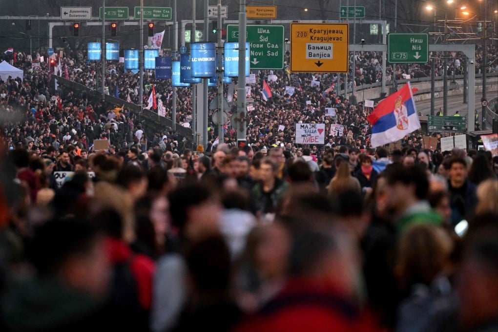 Students and protesters walk on a motorway in Belgrade during a road blocking protest, to pile pressure on the government over a fatal collapse of a railway station roof in November. Photo: AFP