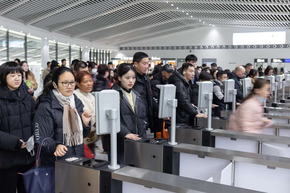 Passengers have their tickets scanned before boarding at the Huzhou East Railway Station in eastern China’s Zhejiang province on Monday.
A record 9 billion inter-regional trips are expected during this year’s 40-day Spring Festival travel rush. Photo: Xinhua