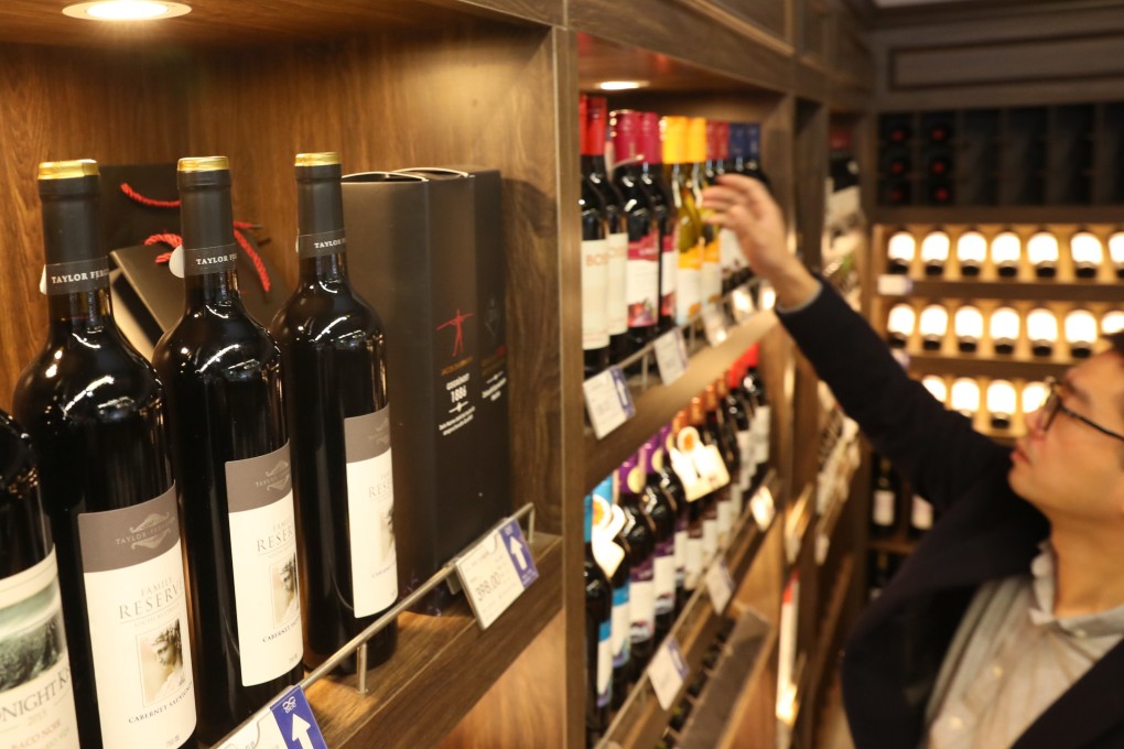 A shopper inspects bottles of Australian wine at a supermarket in China’s Jiangsu province in 2020. Photo: VCG via Getty Images