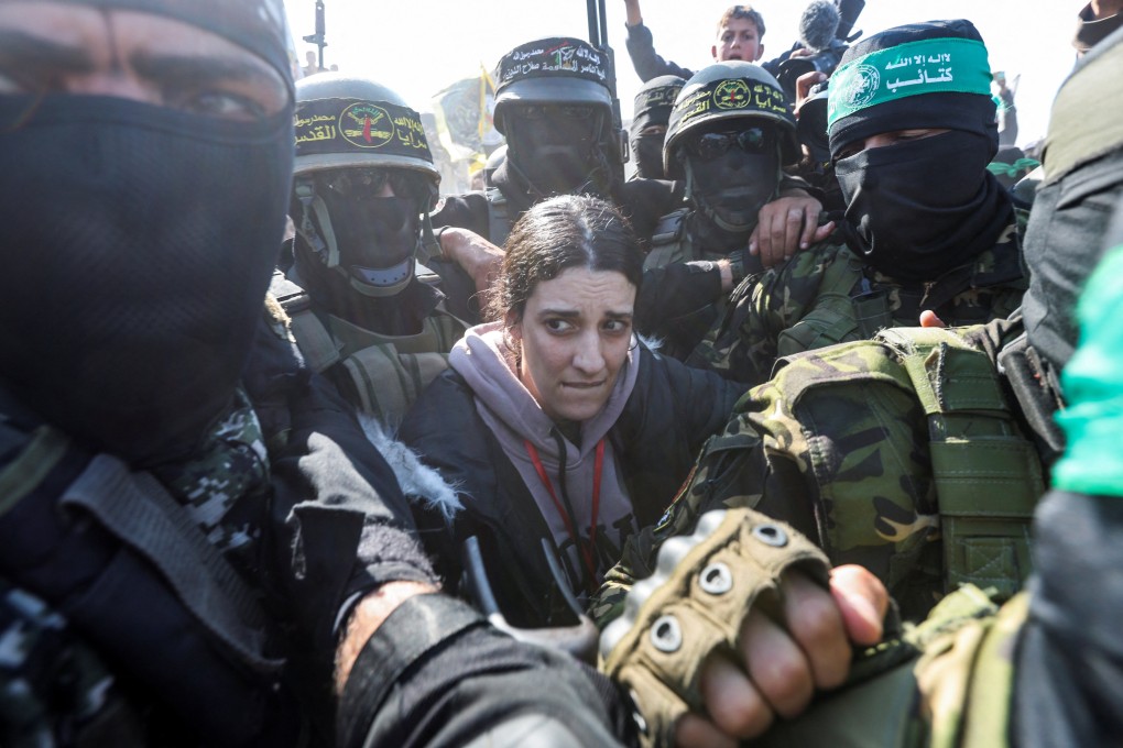 Palestinian militants surround hostage Arbel Yehoud in Khan Younis on the day they hand her to members of the International Committee of the Red Cross as part of a ceasefire and a swap deal between Hamas and Israel. Photo: Reuters