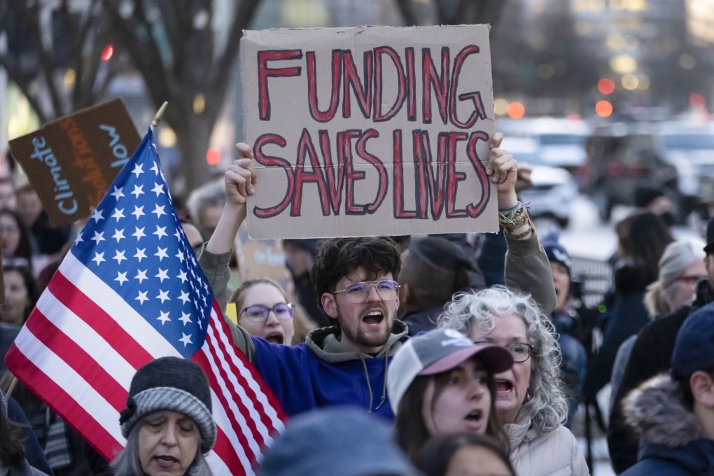 People protest against a funding freeze of federal grants and loans near the White House on Tuesday. Photo: AP