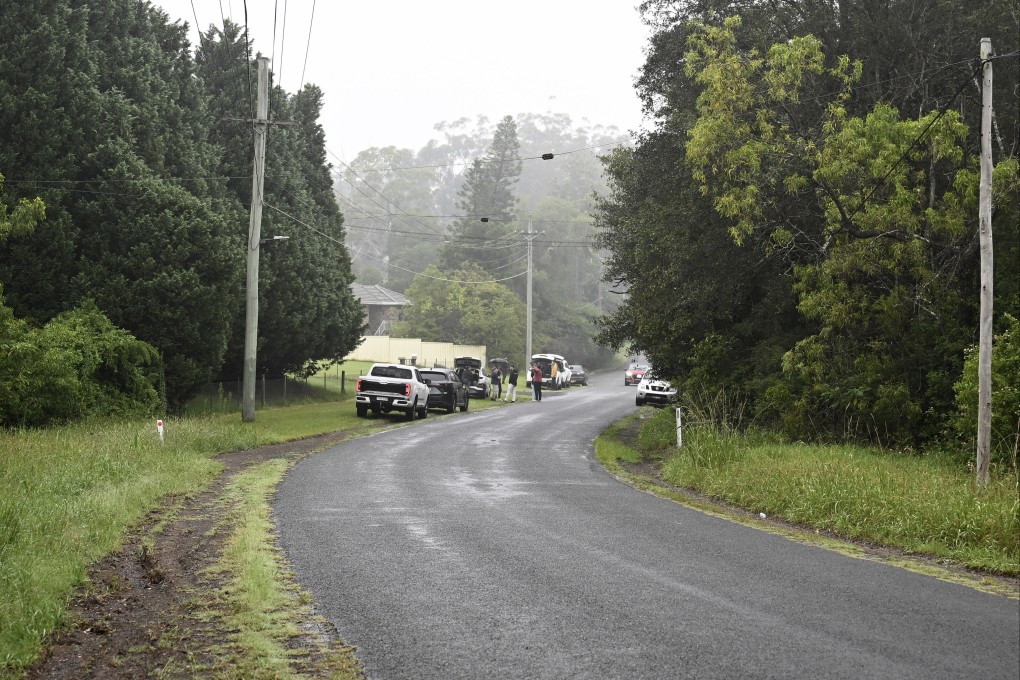 People and vehicles near where a caravan containing explosives was found on the side of a road in the Sydney suburb of Dural. Photo: Bianca De Marchi/AAP Image via AP