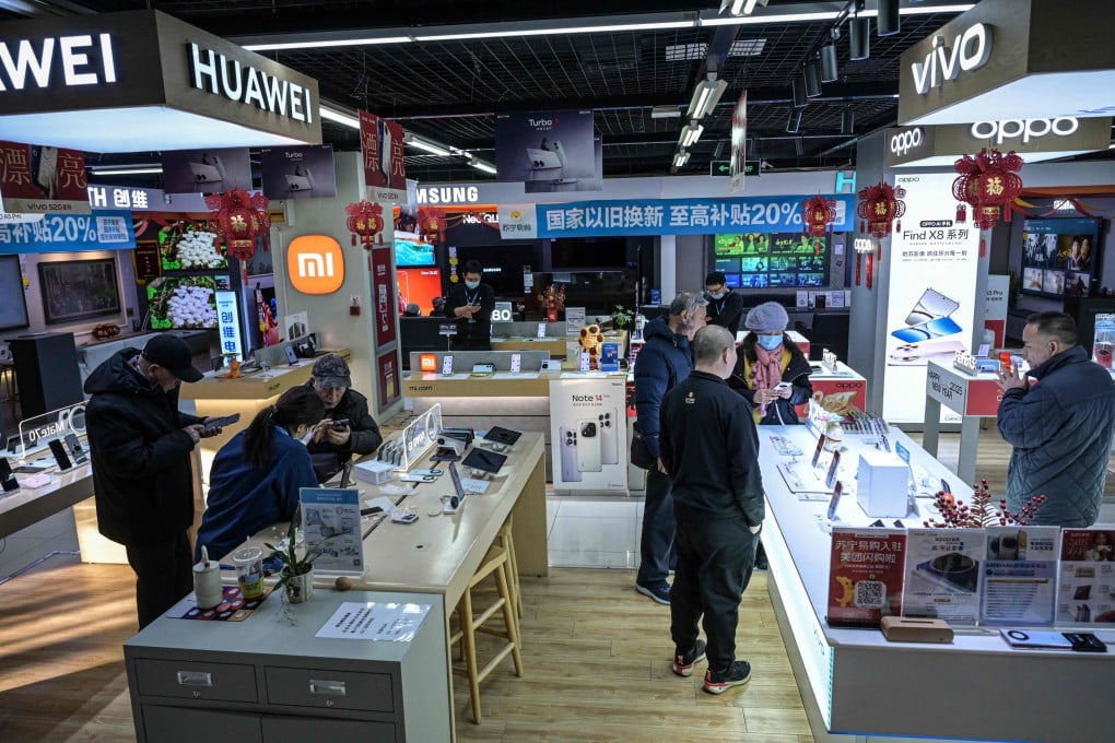 Customers browse at an electronics store in Beijing. The Chinese government is betting on subsidies to boost consumer spending on rice cookers, microwave ovens and smartphones. Photo: AFP
