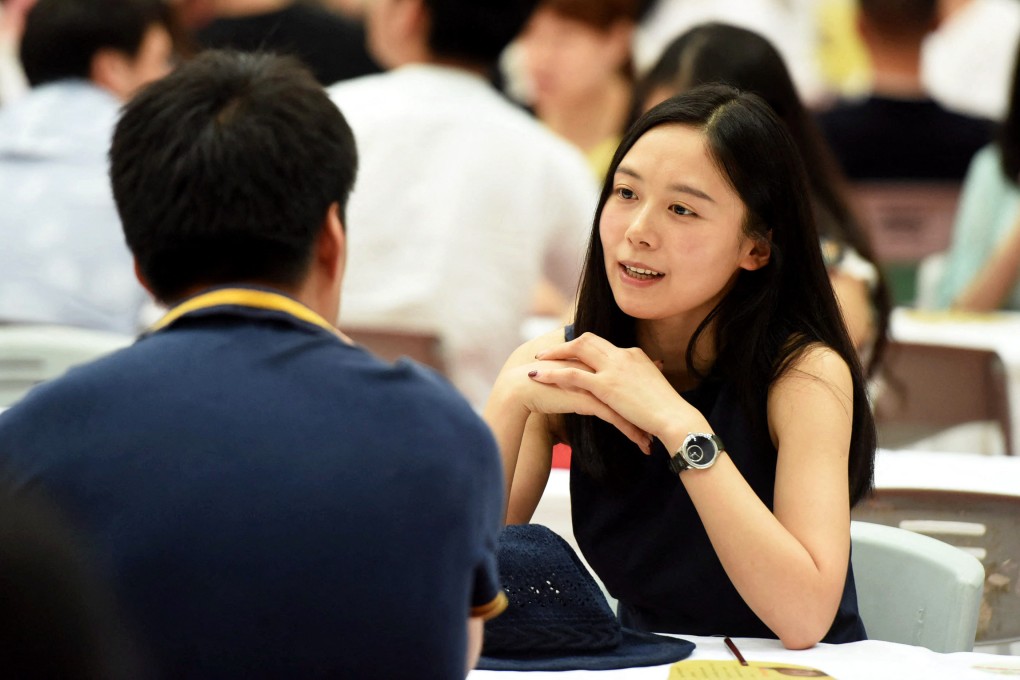 People chat during a matchmaking event in Hangzhou, in eastern China’s Zhejiang province. Both men and women find younger people slightly more attractive on average than older ones on blind dates, according to new research Photo: AFP
