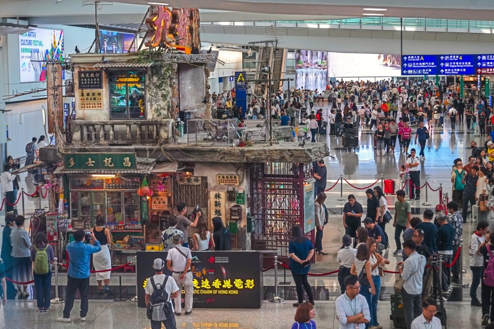 People take photographs at the “Twilight of the Warriors: Walled In” exhibition at Hong Kong International Airport on October 7, 2024. Photo: May Tse