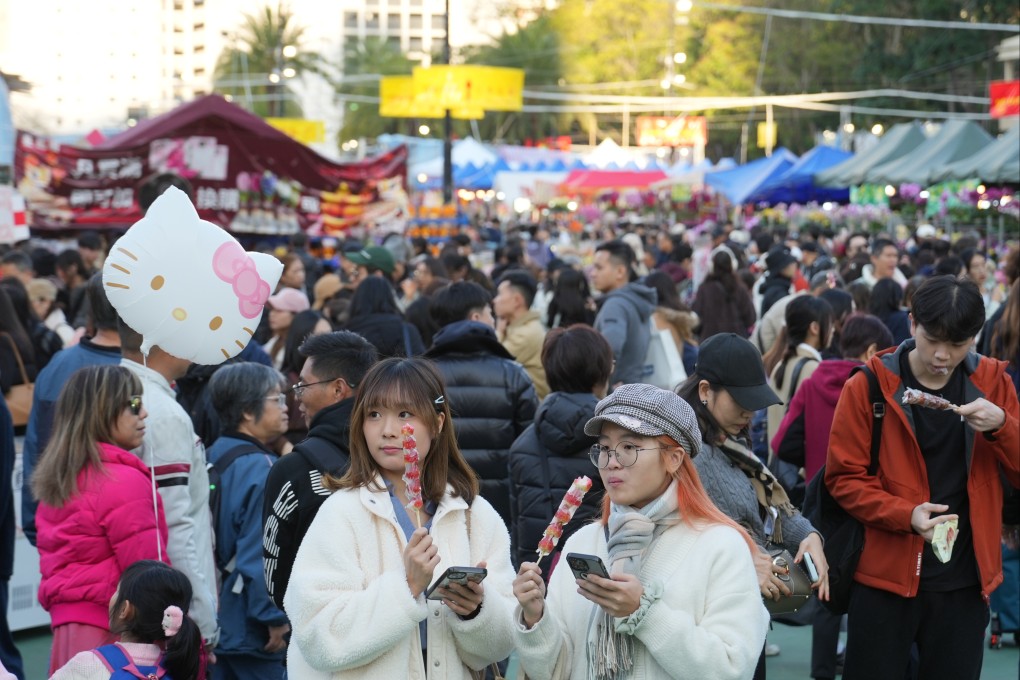 People enjoy a snack at the Lunar New Year Fair at Victoria Park in Causeway Bay on January 27. Photo: Sam Tsang