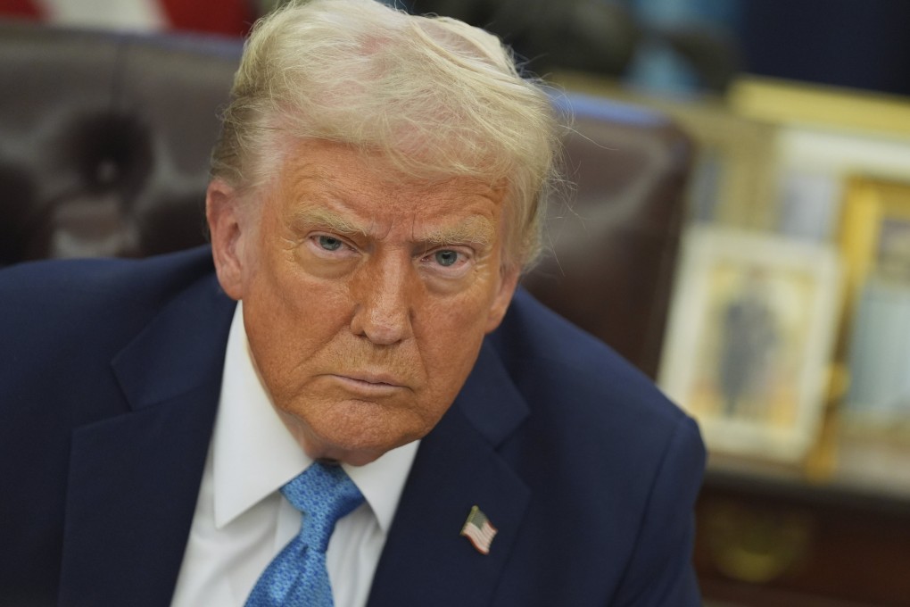 US President Donald Trump speaks to reporters as he signs executive orders in the Oval Office on Friday. Photo: AP