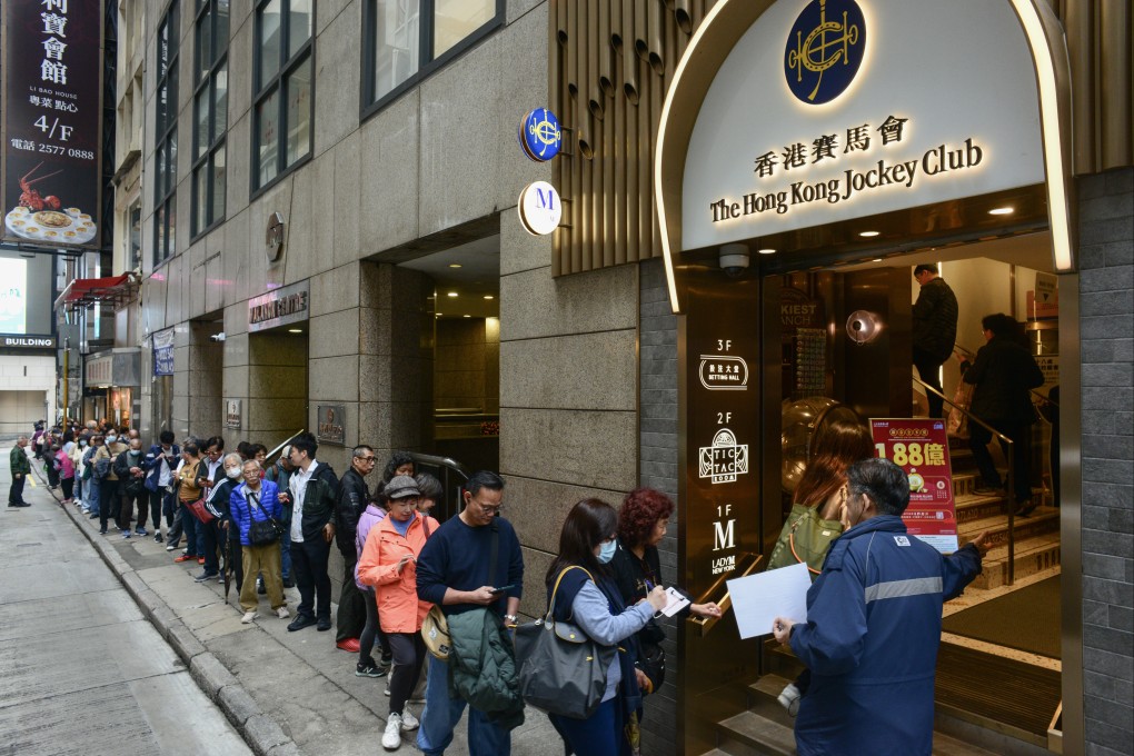 A long queue outside the Hong Kong Jockey Club betting branch in Central. Photo: Antony Dickson