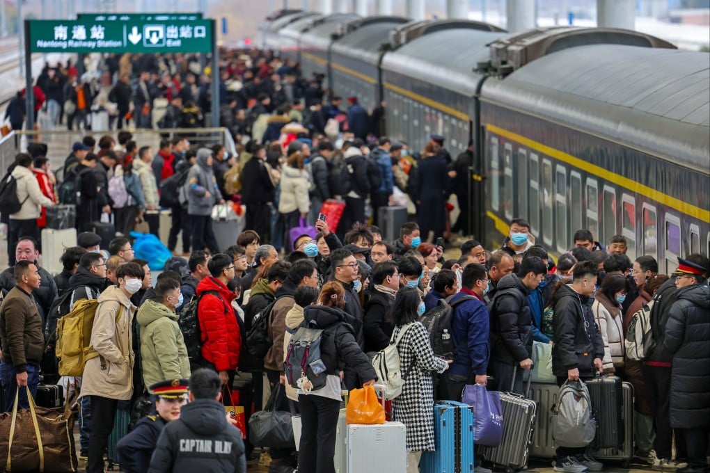 Travellers line up to board a train at a railway station in the east China city of Nantong in Jiangsu province on Monday ahead of Lunar New Year. Photo: AP