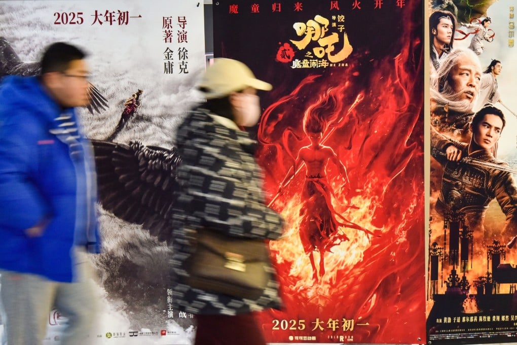 Moviegoers walk past posters of the films Legends of the Condor Heroes: The Gallants, Ne Zha and Creation of the Gods II: Demon Force at a cinema in Fuyang during the Lunar New Year. Photo: Getty Images