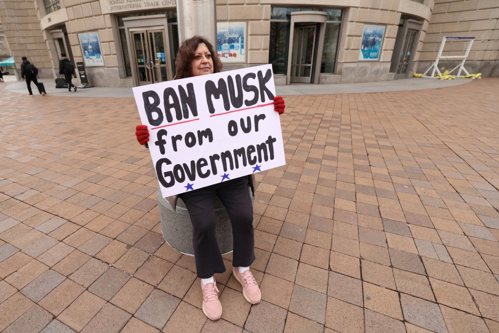 A woman protests against Elon Musk outside the US Agency for International Development (USAID) building in Washington on Monday. Photo: Reuters