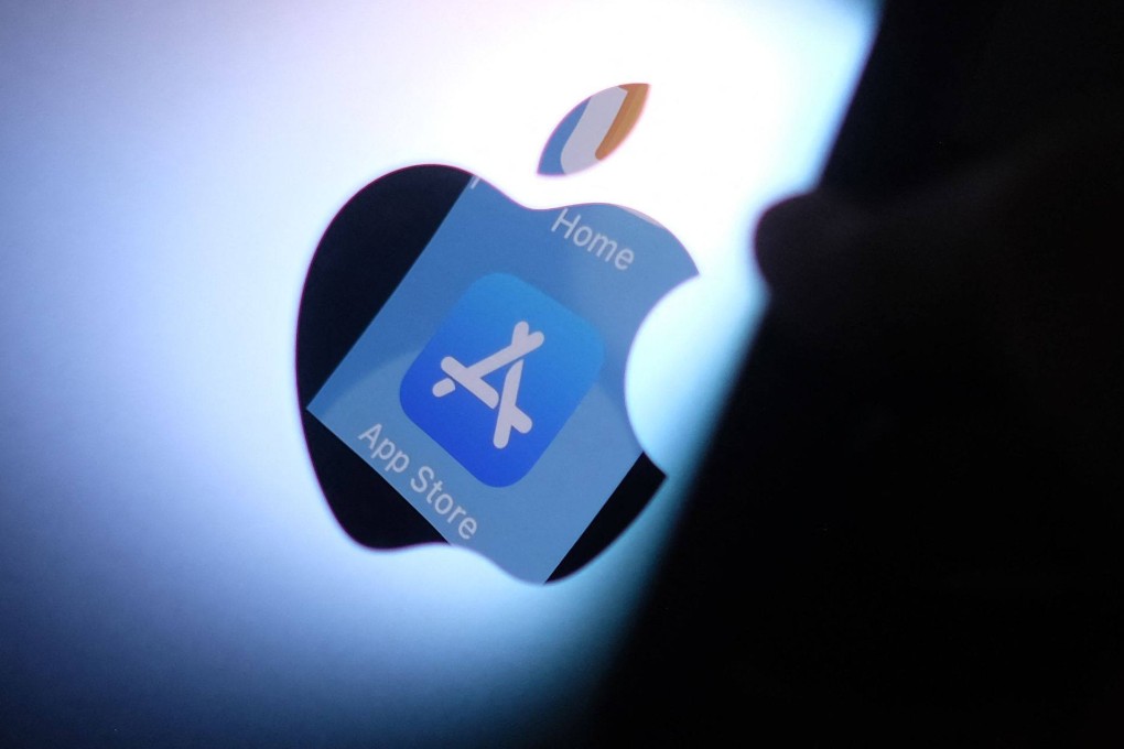 The Apple App Store logo is seen reflected from an iPhone onto the back of an iMac. Photo: AFP