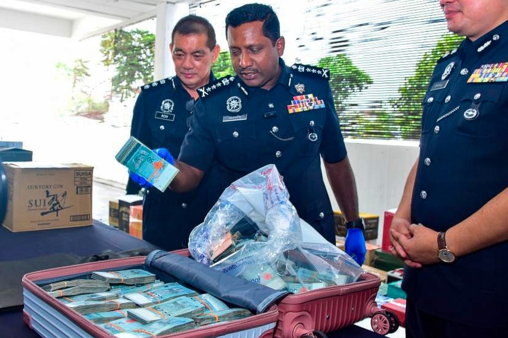 Selangor police chief Hussein Omar Khan (centre) shows off the wads of cash discovered in a suitcase at a shopping centre in Malaysia last year. Photo: Handout