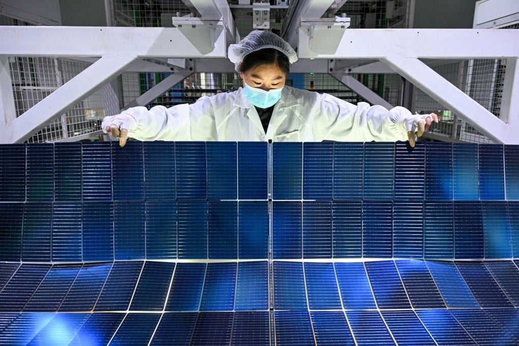 A worker produces photovoltaic modules for solar panels at a factory in Jiangsu province. Photo: AFP