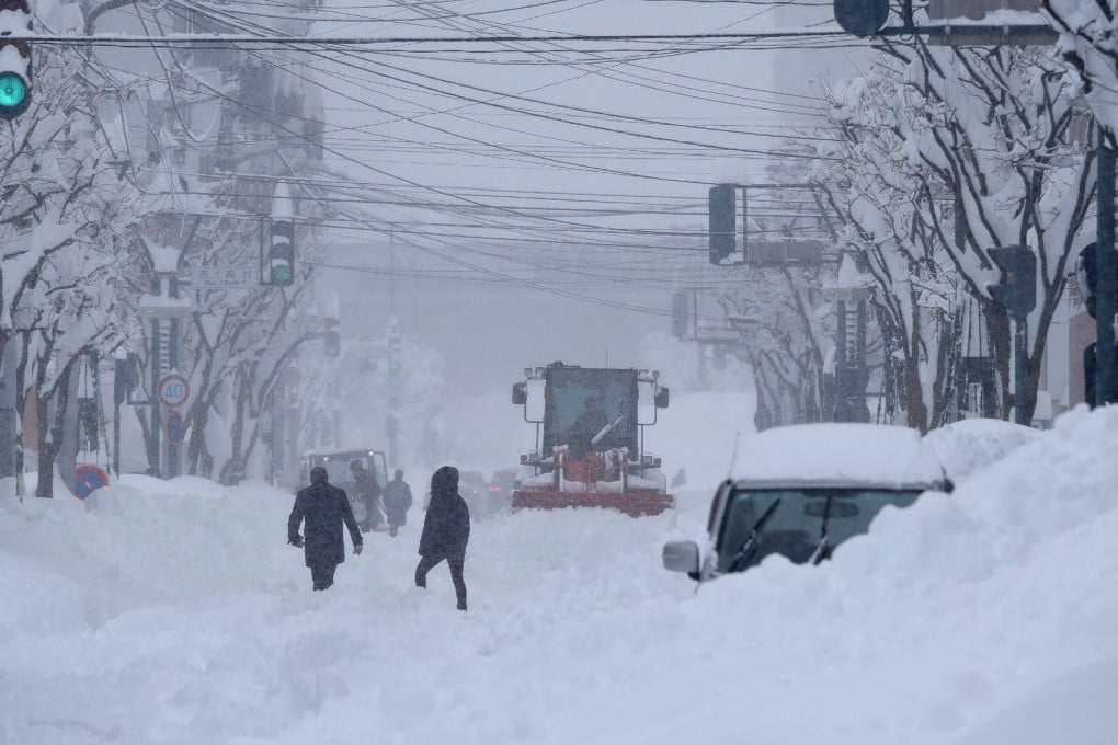 Heavy machinery is used to clear a road in the city of Obihiro, Hokkaido prefecture, on Tuesday as snow falls across northern Japan. Photo: Jiji Press/AFP