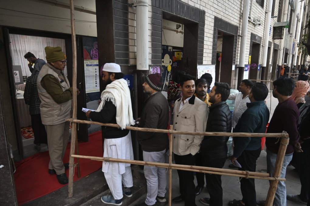People queue to cast their votes for the capital’s state legislature election at a polling booth in New Delhi, India on Wednesday. More than 15 million people are eligible to vote in New Delhi’s election. Photo: AP