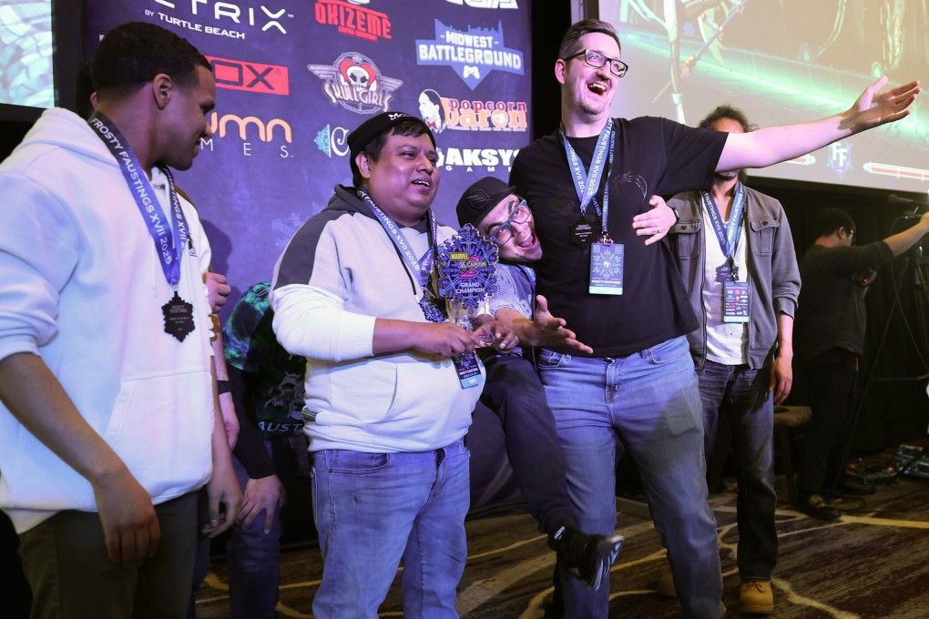 James “Shakira” Martinez (second left) holds the championship trophy for winning the Marvel vs. Capcom 2 tournament at Frosty Faustings XVII at the Westin Chicago Lombard hotel on January 24, 2025, in Lombard, Illinois, US. Other Top 8 finishers included David “Dave Blaine” Thacker (left),  Jacob “Jacobpat84” Tranaude (in black T-shirt) and Jose “DJ Vest” Dominguez (behind Tranaude). Photo: TNS
