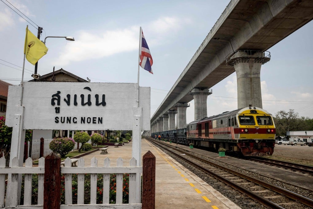 A train sits below an elevated track under construction in March 2023 as part of the first phase of the high-speed railway project in Thailand’s Nakhon Ratchasima province. Photo: AFP