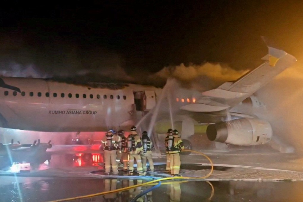 South Korean firefighters put out a blaze from an Air Busan plane at Gimhae airport in Busan on January 28. Photo: Yonhap via Reuters