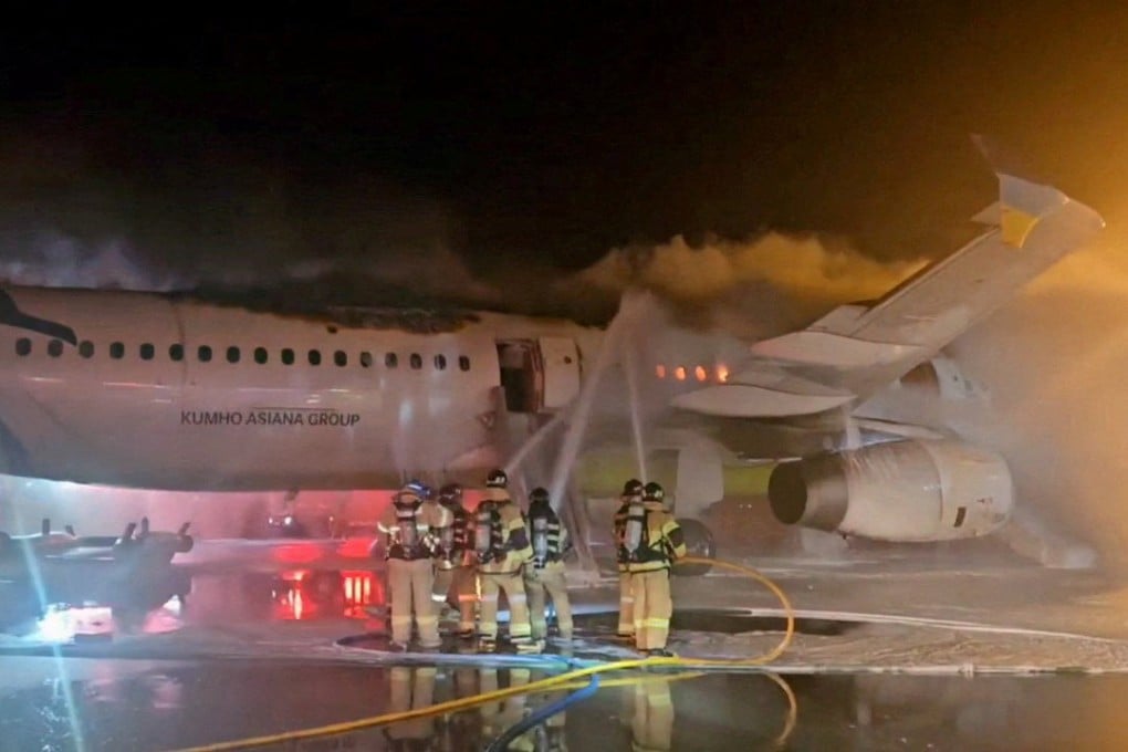 South Korean firefighters put out a blaze from an Air Busan plane at Gimhae airport in Busan on January 28. Photo: Yonhap via Reuters