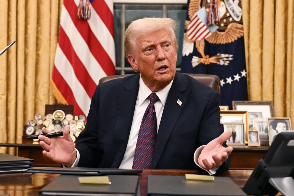 US President Donald Trump speaks to journalists as he signs executive orders in the Oval Office in January. Photo: TNS