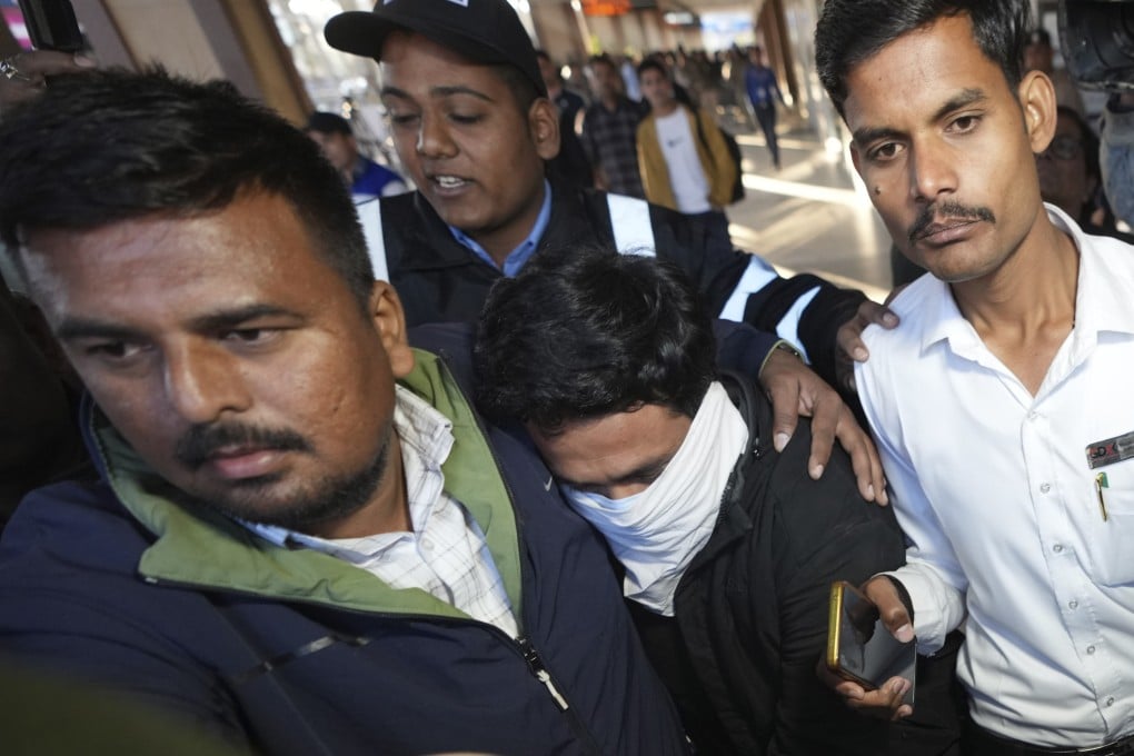 Indian police escort a migrant man (centre) who arrived in Amritsar on Wednesday after being deported from the United States. Photo: AP