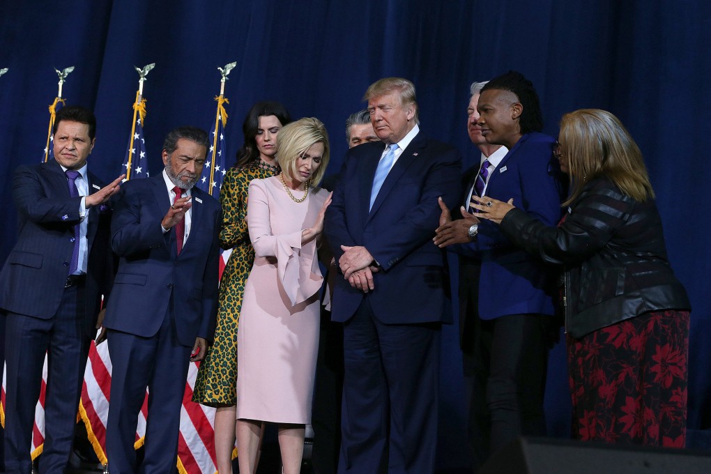 A group of religious leaders pray for President Donald Trump during an “Evangelicals for Trump” campaign rally at El Rey Jesus Evangelical church in Kendall, Florida, on January 3, 2020. Photo: Miami Herald/TNS)