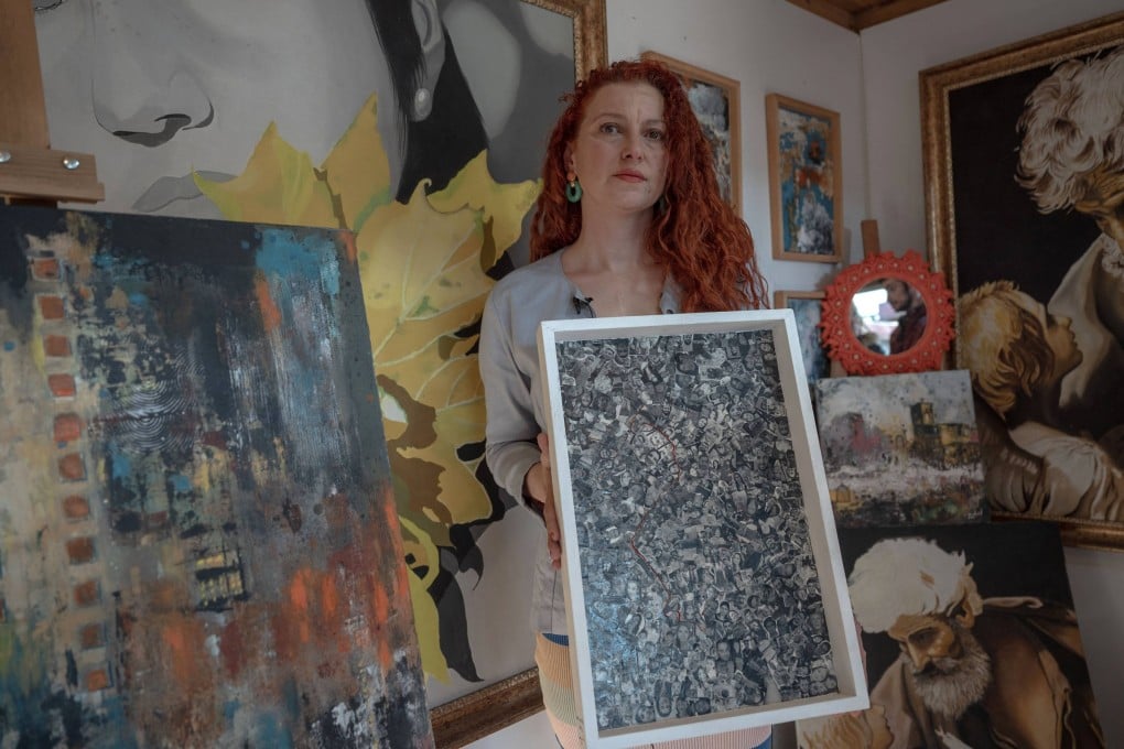 Turkish artist Emil Genc with her paintings in her workshop at the Antakya Art and Culture Market, which showcases the work of more than 70 local artists two years after an earthquake killed 53,000 people. Photo: AFP