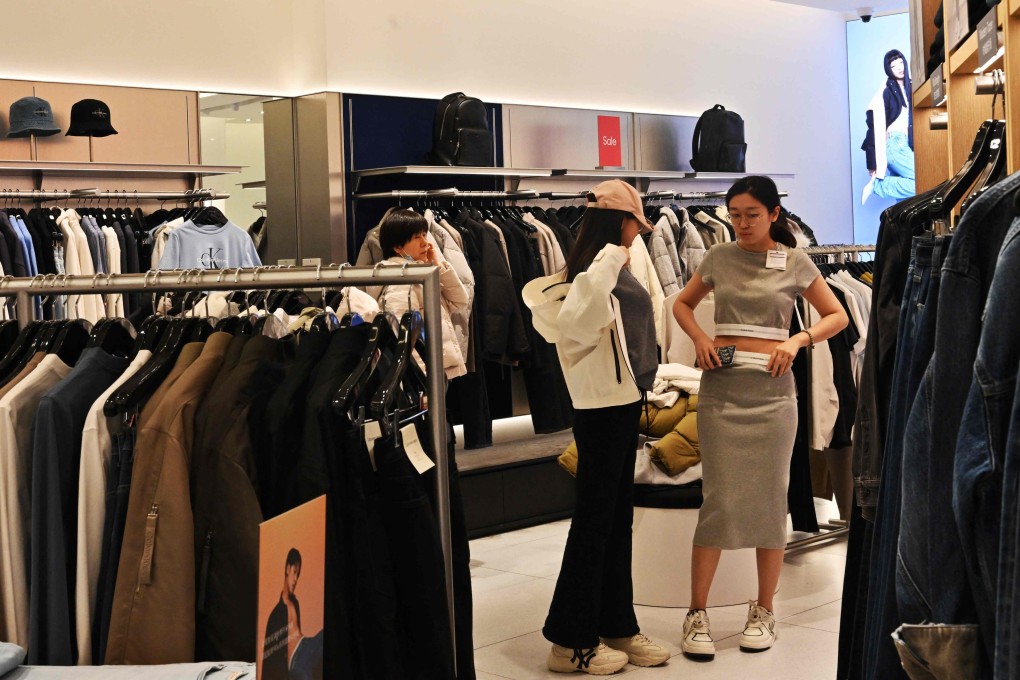 People shop for clothes at a Calvin Klein store in a Beijing shopping centre on Wednesday. Photo: AFP