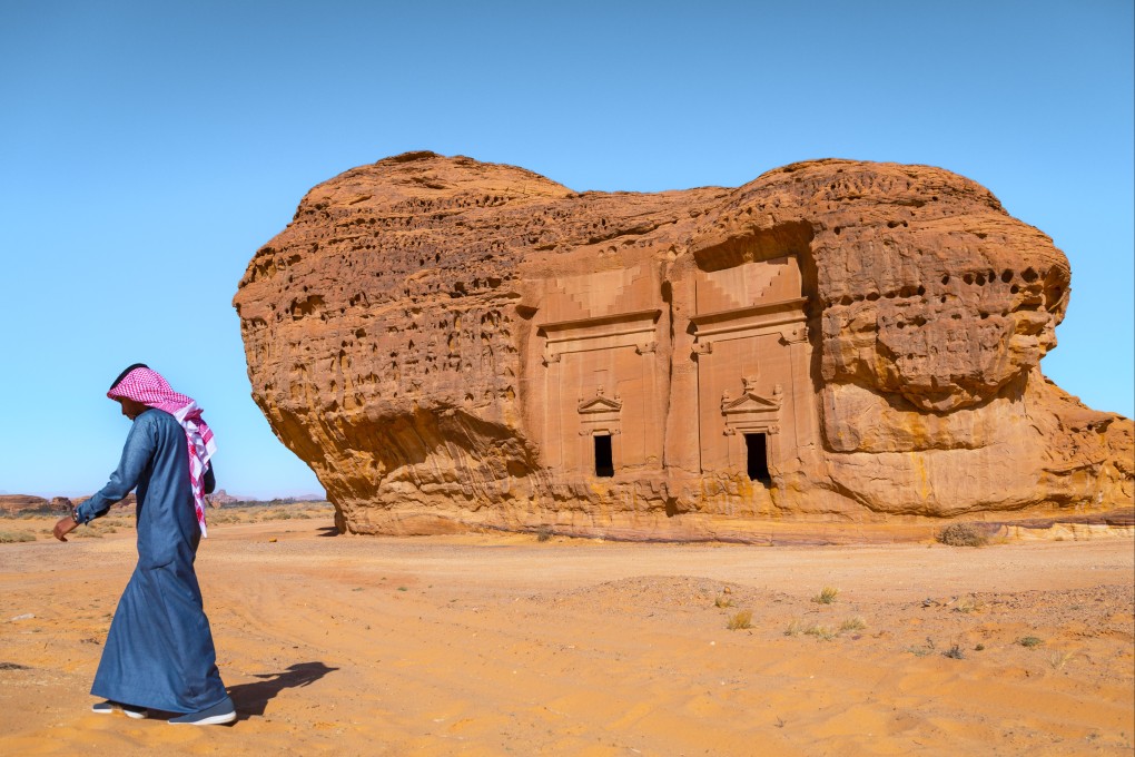 A Saudi man walks in front of tombs in the al-Hijr archaeological site at Hegra, also known as Mada’in Saleh. Photo: Getty Images