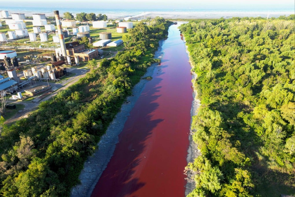 An aerial view shows an unusual reddish colour in the Sarandi Canal seeping into the Rio de la Plata River on the outskirts of Buenos Aires on Thursday. Photo: AFP