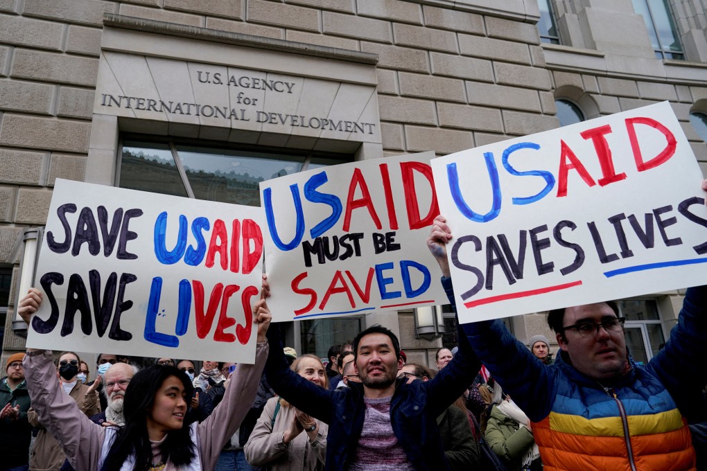 Protesters hold placards outside the USAID building in Washington on Monday. Photo: Reuters
