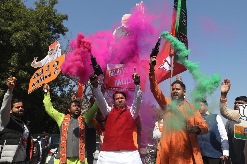 Bharatiya Janata Party (BJP) party workers celebrate the party’s lead in votes for the Delhi Assembly elections, on Saturday. Photo: EPA-EFE