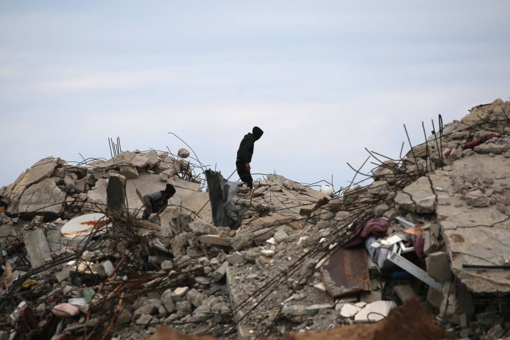 A displaced Palestinian man inspects the damage to his home in Gaza City on Sunday, after crossing the Netzarim corridor from southern Gaza into the enclave’s north. Photo: AFP