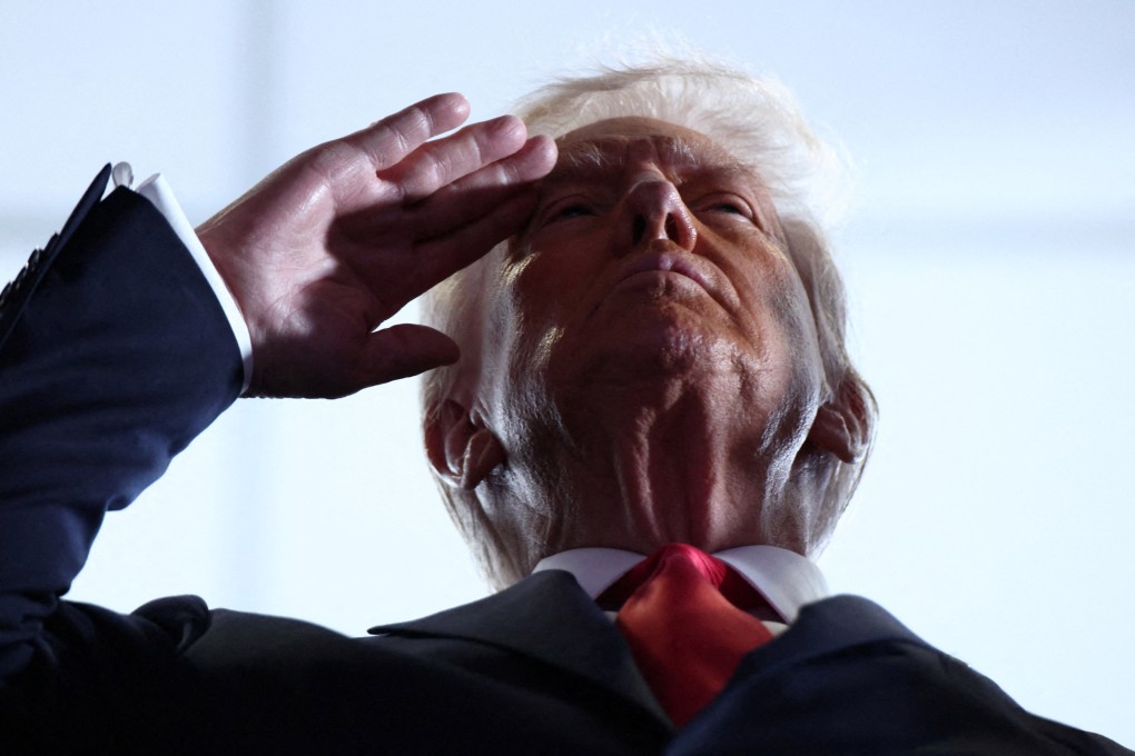 US President Donald Trump salutes before the Super Bowl on Sunday. Photo:  Reuters