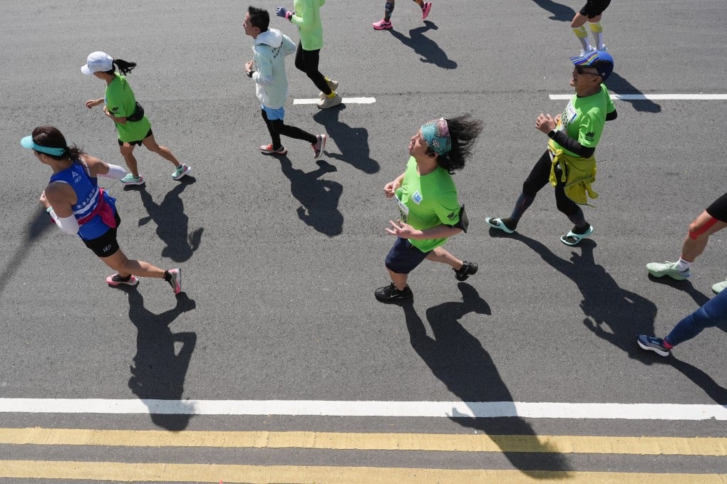 Runners pass along Admiralty during this year’s Standard Chartered Hong Kong Marathon. Photo: Eugene Lee