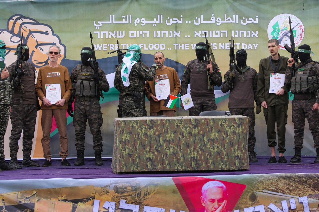 Hamas fighters escort Israeli hostages before handing them over to a Red Cross team in Deir al-Balah, central Gaza on Saturday. Photo: AFP