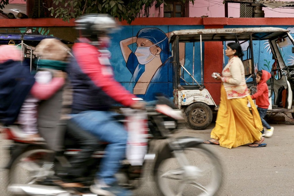 A woman walks past a mural promoting face masks in Varanasi, India, last month. Much of the disinformation about HMPV in early January came from social media accounts with an Indian focus, before spreading to others with audiences in Africa, Indonesia and Japan. Photo: AFP