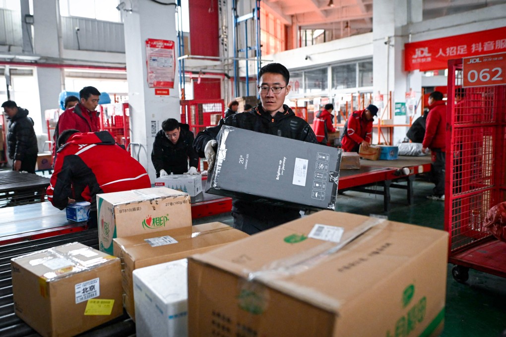 Workers sort packages for delivery at a JD.com warehouse in Beijing on November 11, 2024. Photo: AFP