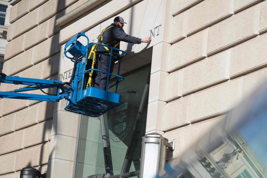 The sign for the US Agency for International Development at its headquarters in Washington is removed on Friday. Photo: Getty Images via AFP