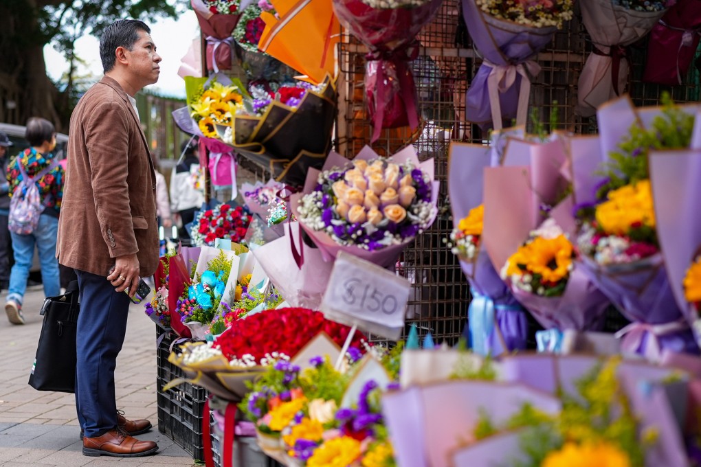 A man browses flowers at a market in Mong Kok ahead of Valentine’s Day. Photo: Eugene Lee